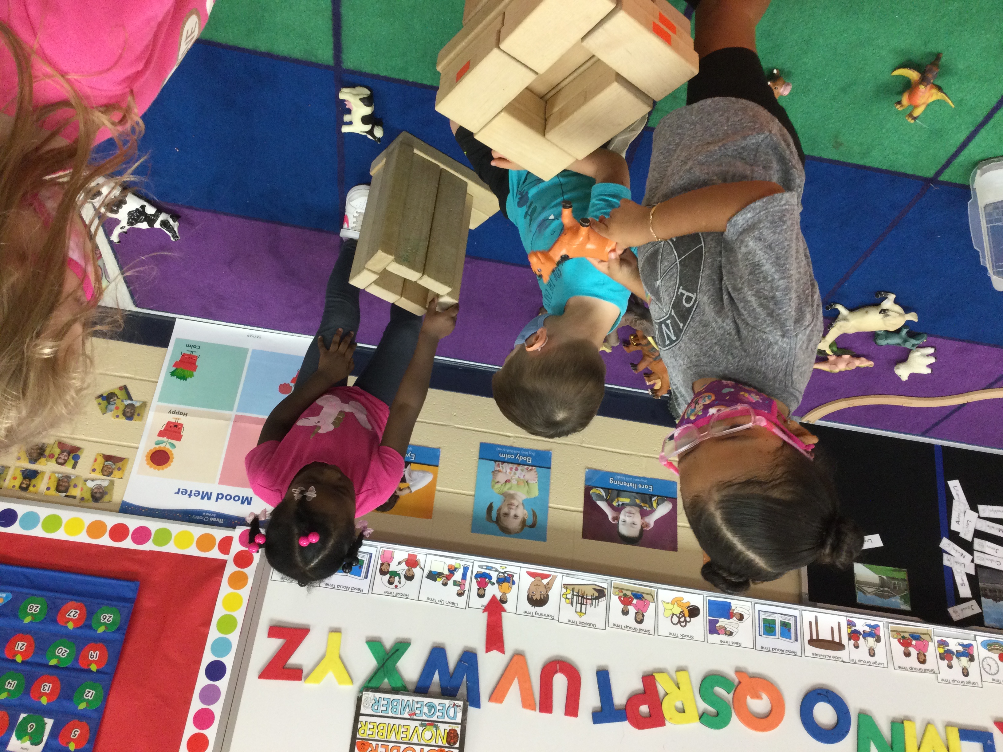 Students playing with wooden blocks.