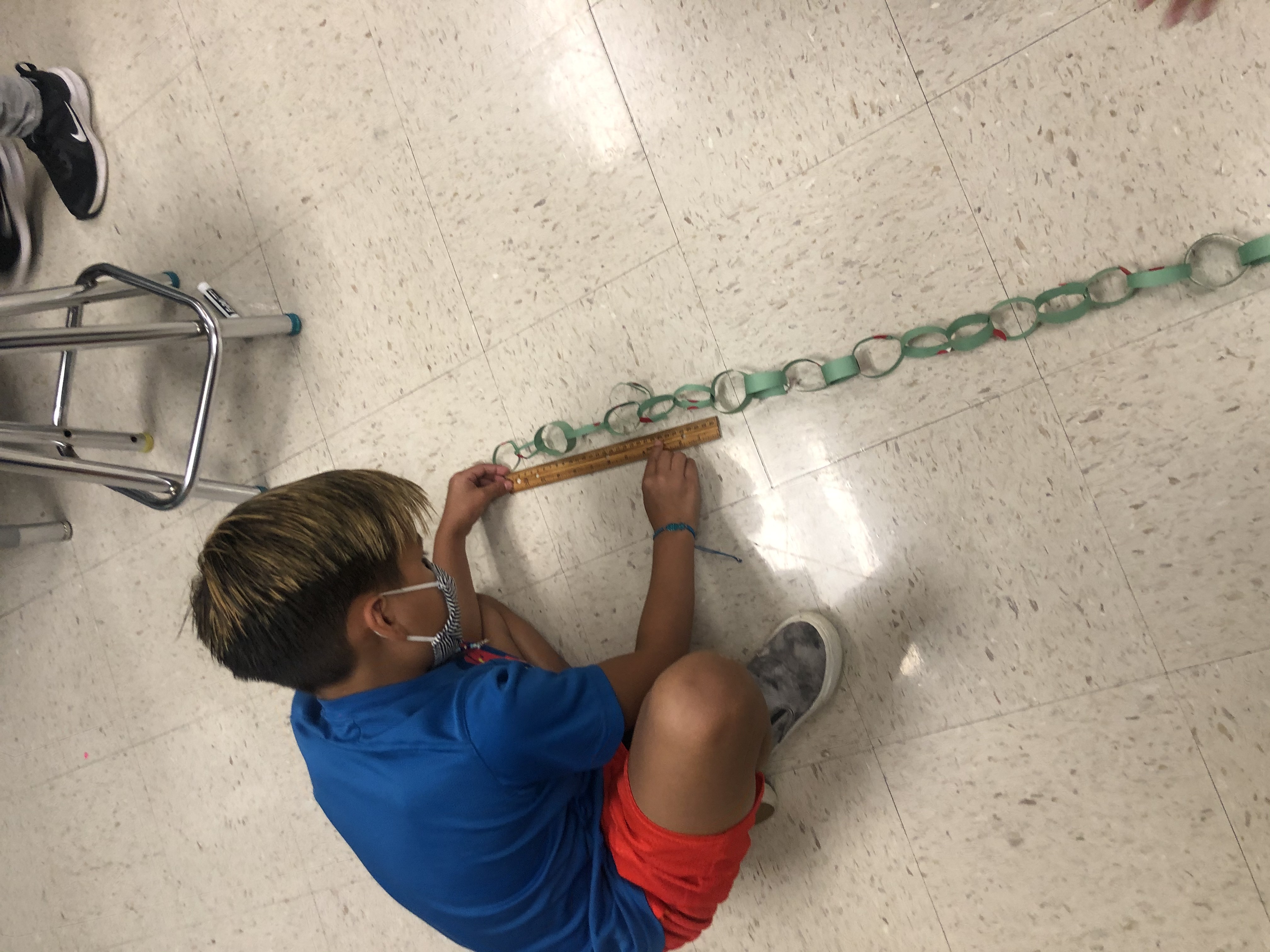 Boys measuring chain link project.