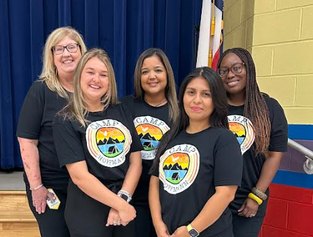 Casual photo of kinder team wearing matching Hoffmann shirts. 