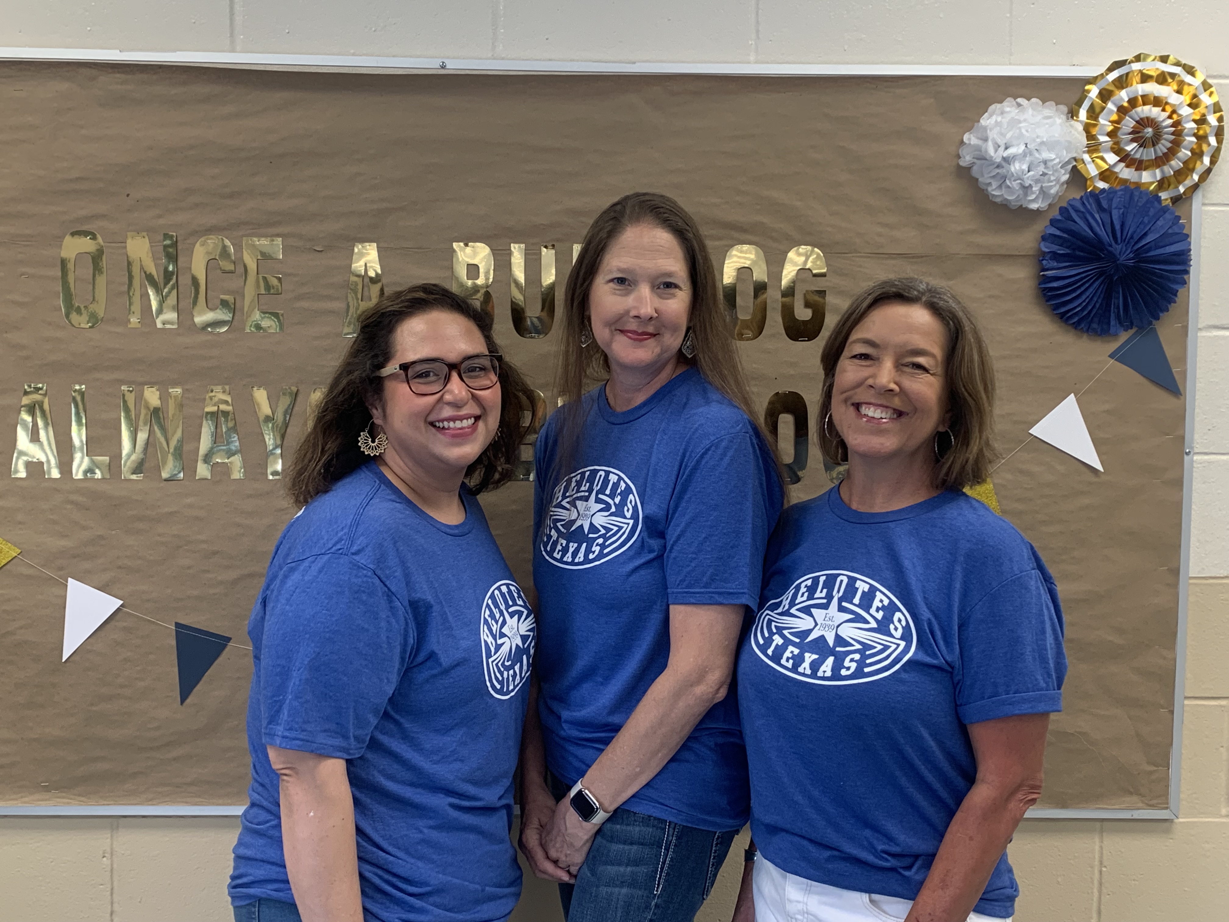 Pic of fifth grade team in front of bulletin board