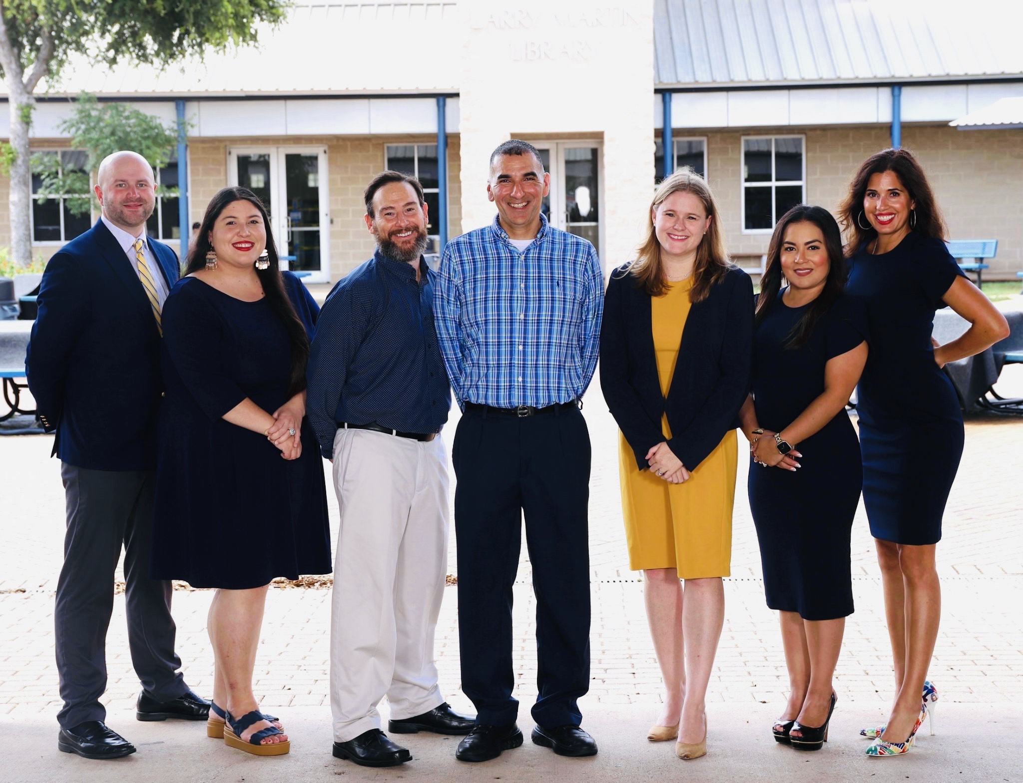 A group photo of our admin team in front of the library