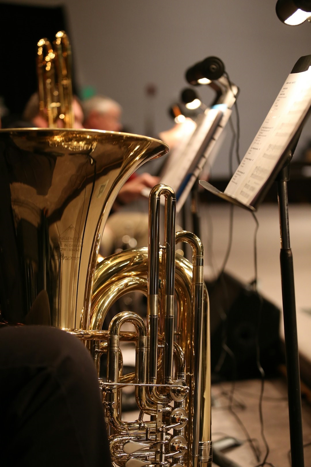 brass horn near sheet music stand