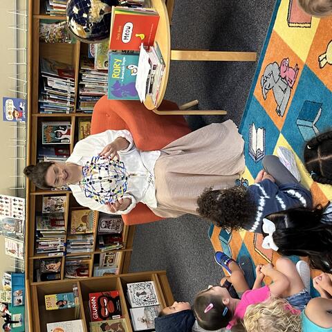 Ms. Mosley using the breathing ball with a Pre-K class.