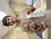 Student holding his winning sculpture of a unique vase